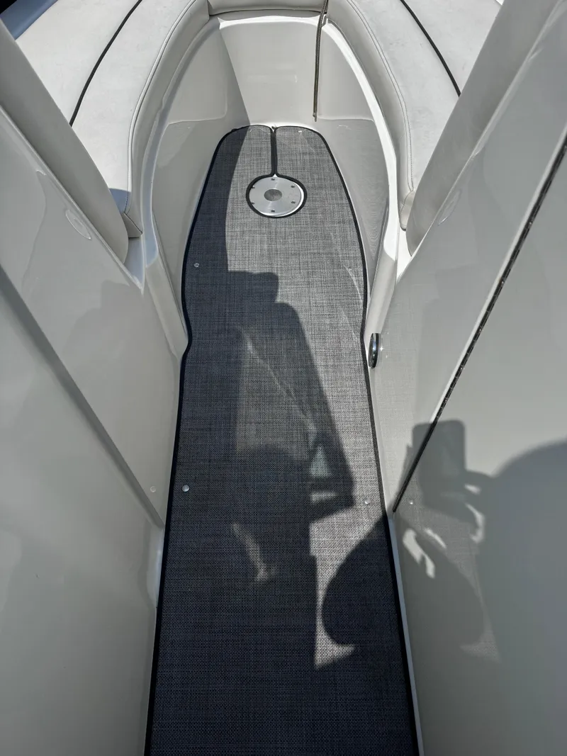 Slide: The Image of Interior view of 2007 Sea Ray 270 SLX boat with gray flooring and white seating. - 13