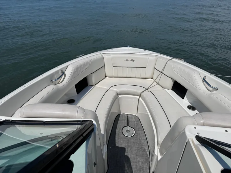 Slide: The Image of 2007 Sea Ray 270 SLX boat interior with white seating on calm water. - 6