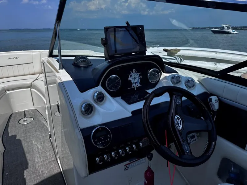 Slide: The Image of 2007 Sea Ray 270 SLX boat dashboard with steering wheel and navigation equipment, on open water. - 8