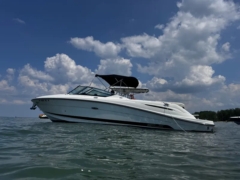 The Image of 2007 Sea Ray 270 SLX boat on calm water under a partly cloudy sky. - 2