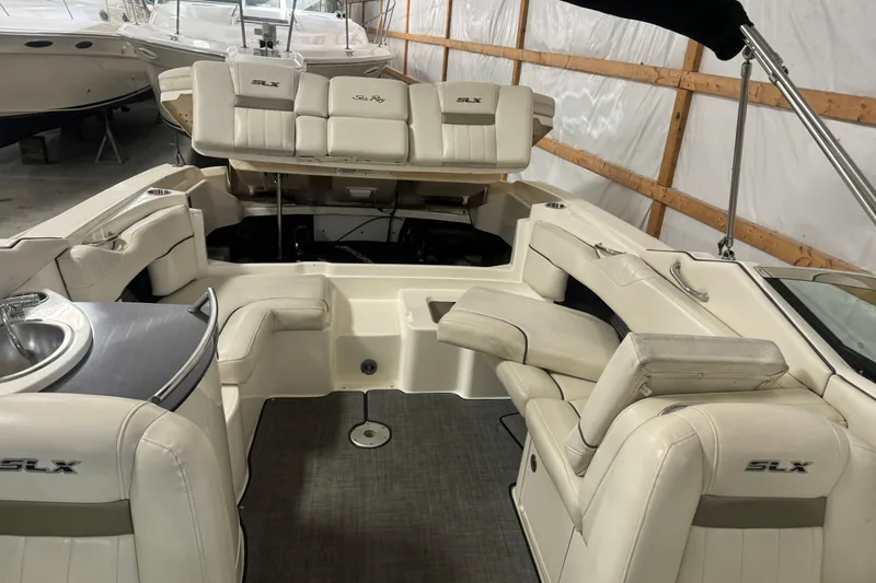 Slide: The Image of 2007 Sea Ray 270 SLX boat interior with white seating and built-in sink. - 25