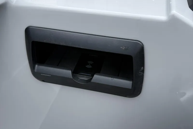 Slide: The Image of Close-up of a 2026 Bentley Pontoons 223 Quad Swingback wireless charging station. - 10