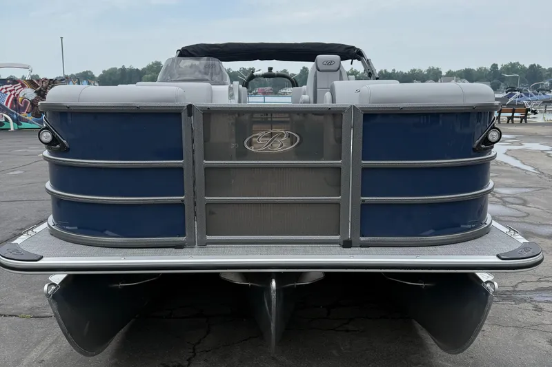 Slide: The Image of 2026 Bentley Pontoons 223 Quad Swingback, rear view, docked on a cloudy day. - 5