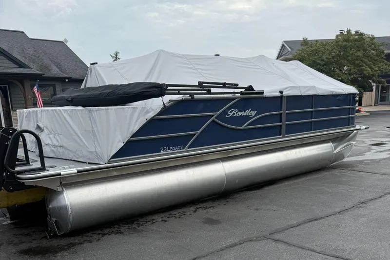 Slide: The Image of 2026 Bentley Pontoons 223 Quad Swingback, covered, parked outdoors on a wet surface. - 6