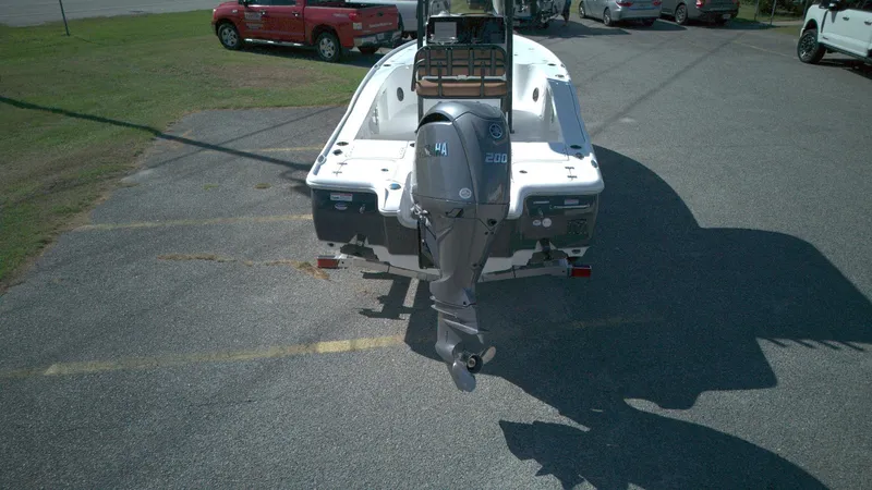 Slide: The Image of 2026 Sea Hunt BX22BR boat with Yamaha 200 outboard motor, parked on asphalt. - 1
