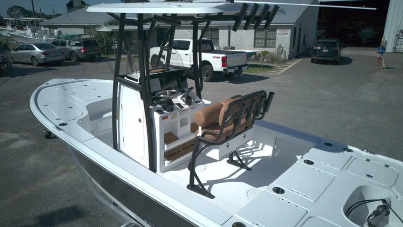 Slide: The Image of 2026 Sea Hunt BX22BR boat with center console and seating, parked outdoors. - 2