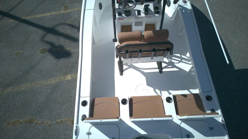 Slide: The Image of 2026 Sea Hunt BX22BR boat interior with brown seating and steering console. - 3