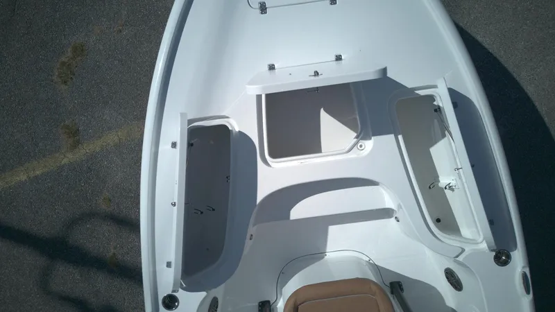 Slide: The Image of 2026 Sea Hunt BX22BR boat interior with open storage compartments, viewed from above. - 4