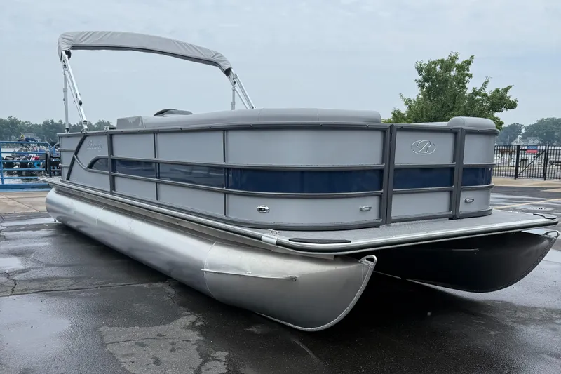 Slide: The Image of 2026 Bentley Pontoons Legacy 240 Cruise XL pontoon boat on wet pavement, overcast sky. - 7