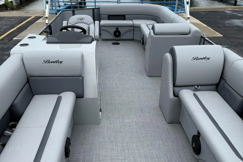 Slide: The Image of 2026 Bentley Pontoons Legacy 240 Cruise XL interior with luxurious gray seating and spacious layout. - 8
