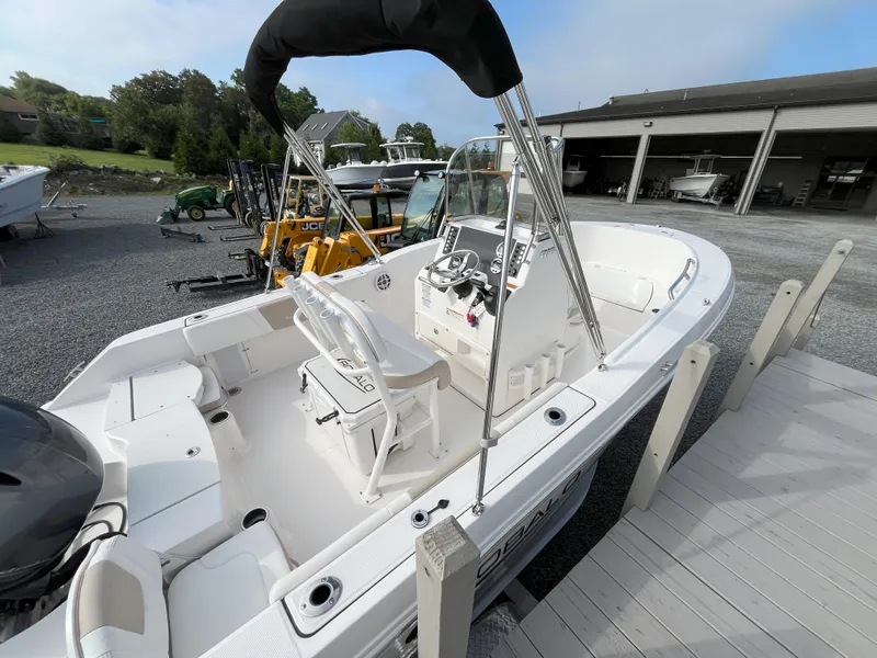 Slide: The Image of 2025 Robalo R180 Center Console boat interior with steering wheel and controls. - 2