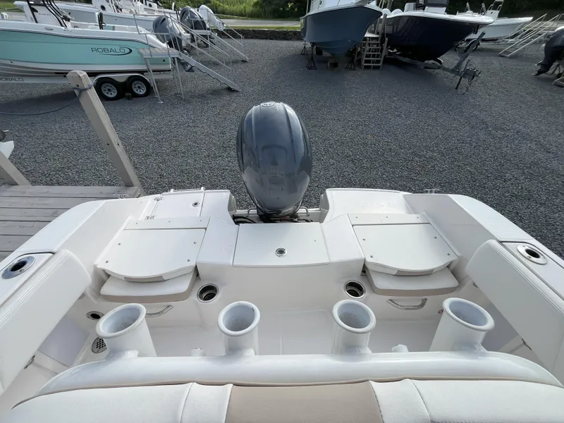 Slide: The Image of 2025 Robalo R180 Center Console boat interior with drainage and warning sign. - 4