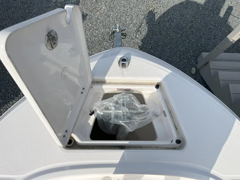 Slide: The Image of 2025 Robalo R180 Center Console boat with white seating and sleek design in a showroom. - 9