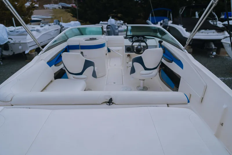 Slide: The Image of 2013 Sea Ray 220 Sundeck boat interior with white and blue seating. - 4