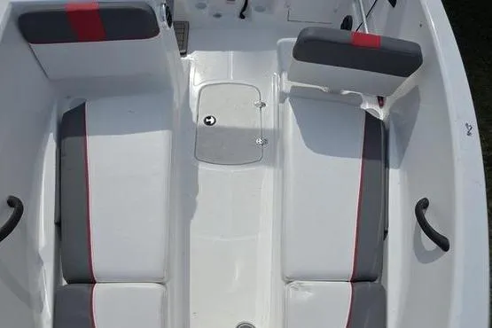 Slide: The Image of 2023 Tahoe T16 boat interior with gray and red seating, white deck, and storage compartment. - 14