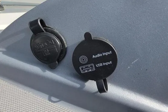 Slide: The Image of 2023 Tahoe T16 audio and USB input ports on a gray dashboard. - 17