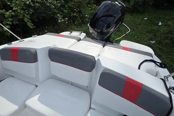 Slide: The Image of 2023 Tahoe T16 boat interior with gray and red seating, outboard motor visible. - 7