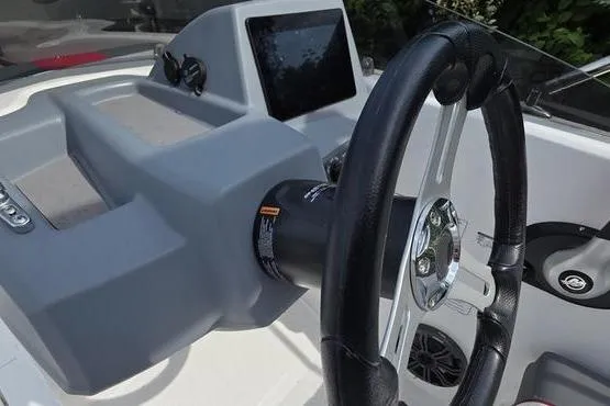 Slide: The Image of 2023 Tahoe T16 boat dashboard with steering wheel and control panel. - 8