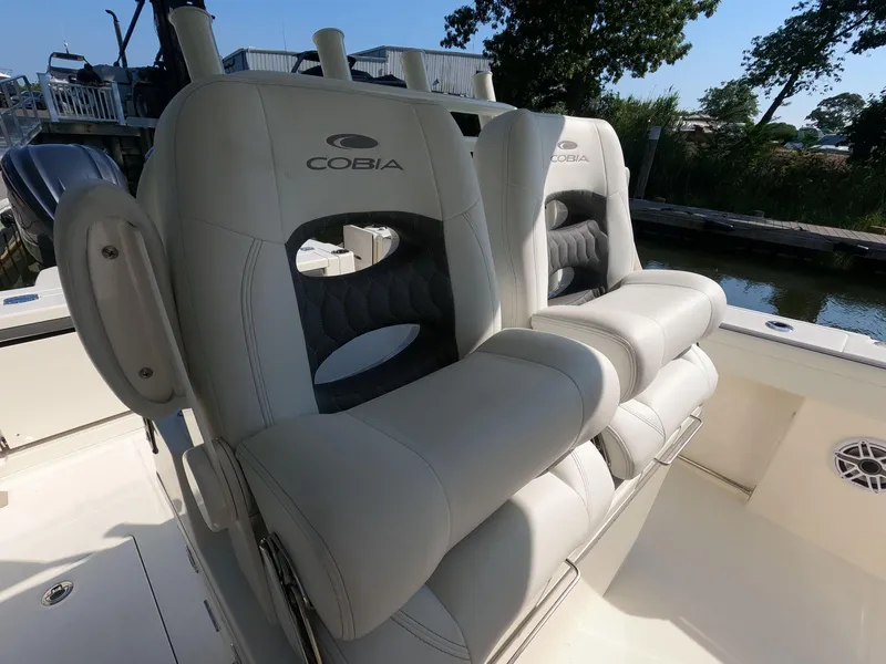 Slide: The Image of 2026 Cobia 285 Center Console boat seats, featuring luxurious white upholstery and sleek design. - 13