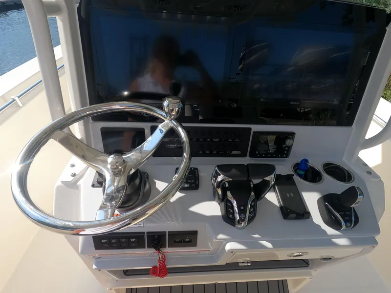 Slide: The Image of 2026 Cobia 285 Center Console helm with steering wheel and controls. - 15