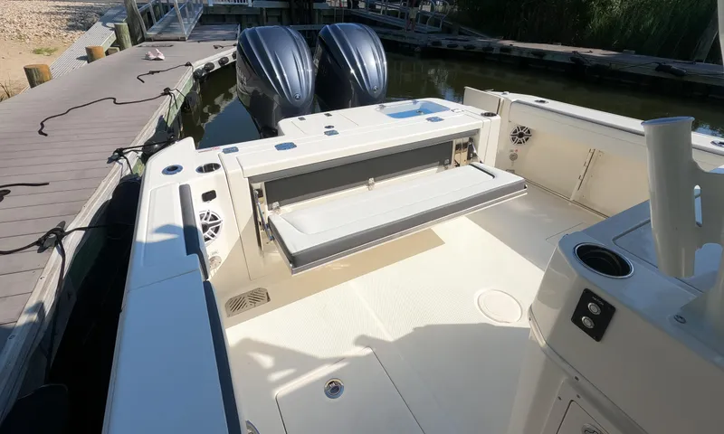 Slide: The Image of 2026 Cobia 285 Center Console boat with dual engines docked at a marina. - 3