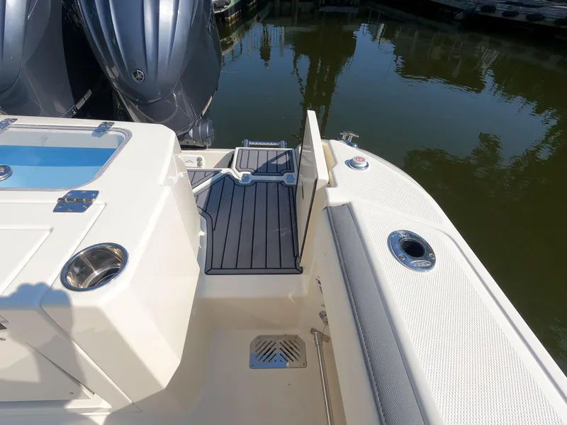 Slide: The Image of 2026 Cobia 285 Center Console boat stern with dual engines and sleek deck design. - 5