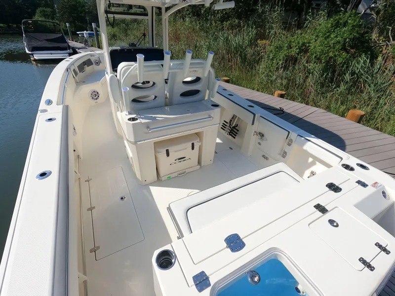 Slide: The Image of 2026 Cobia 285 Center Console boat docked, featuring spacious deck and seating. - 6
