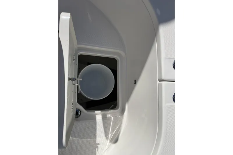 Slide: The Image of 2025 Robalo R222 Center Console boat storage compartment with open hatch. - 13