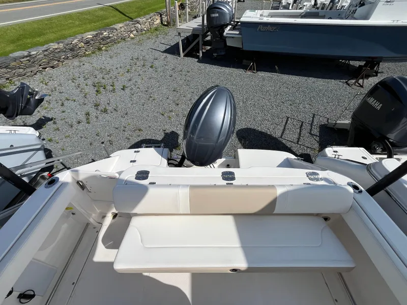 Slide: The Image of 2025 Robalo R222 Center Console boat with Yamaha outboard engine, parked on gravel. - 3