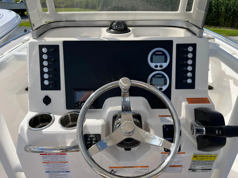 Slide: The Image of 2025 Robalo R222 Center Console dashboard with steering wheel and control panel. - 5
