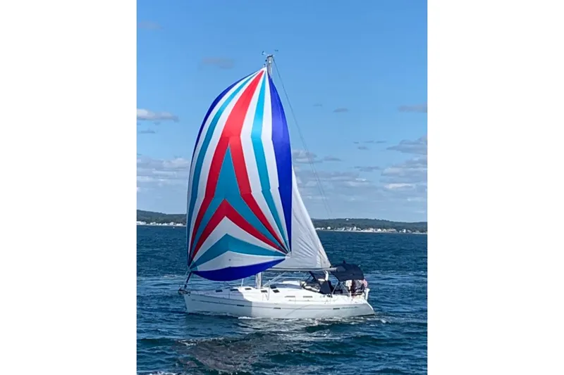 The Image of Sailing yacht Beneteau 393 (2003) with colorful spinnaker on open water. - 0