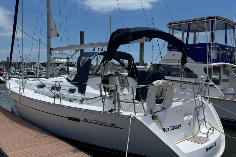 Slide: The Image of 2003 Beneteau 393 sailboat docked at marina under clear blue sky. - 3