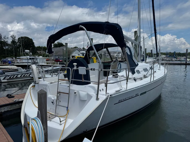 Slide: The Image of 2003 Beneteau 393 sailboat docked at marina under cloudy sky. - 5