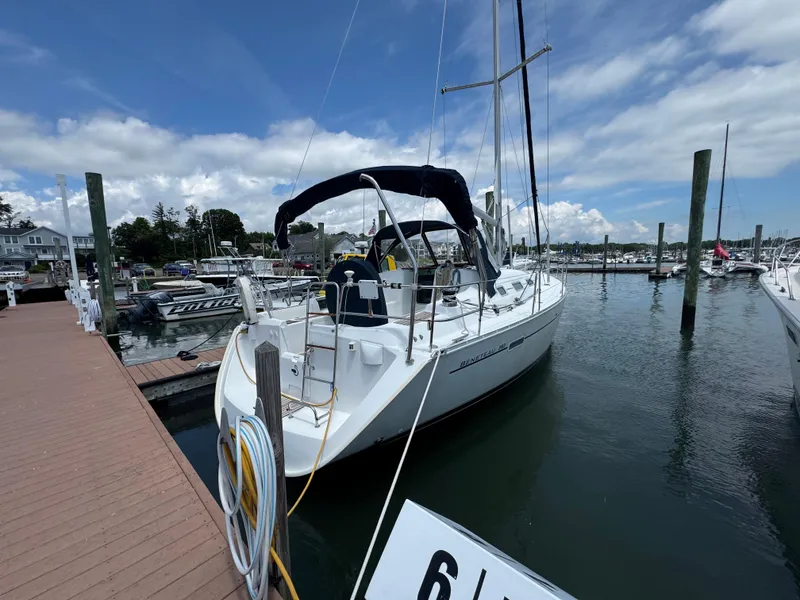 Slide: The Image of Sailboat Beneteau 393, 2003 model, docked at marina under blue sky. - 6
