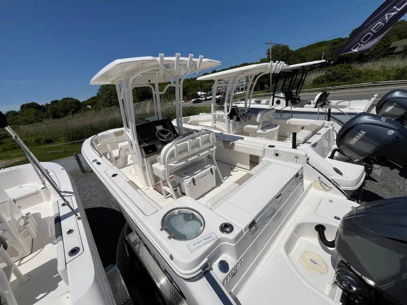 Slide: The Image of 2024 Robalo R230 Center Console boat dashboard with steering wheel and controls. - 2