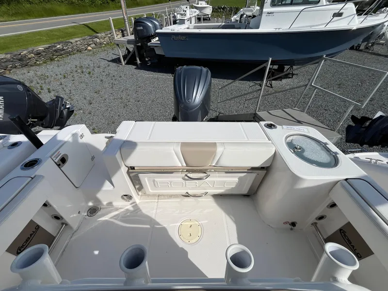 Slide: The Image of 2024 Robalo R230 Center Console boat interior with cushioned seating and helm. - 3