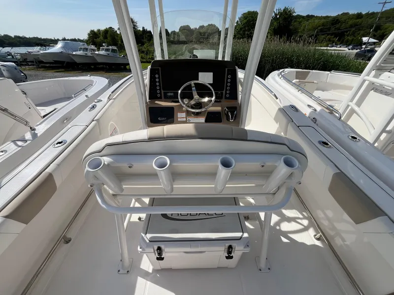 Slide: The Image of 2024 Robalo R230 Center Console storage compartment with open lid and packaged contents. - 5