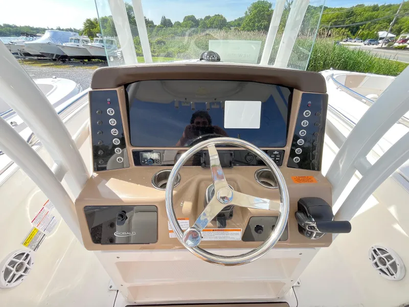 Slide: The Image of 2024 Robalo R230 Center Console boat interior with compact marine toilet. - 7
