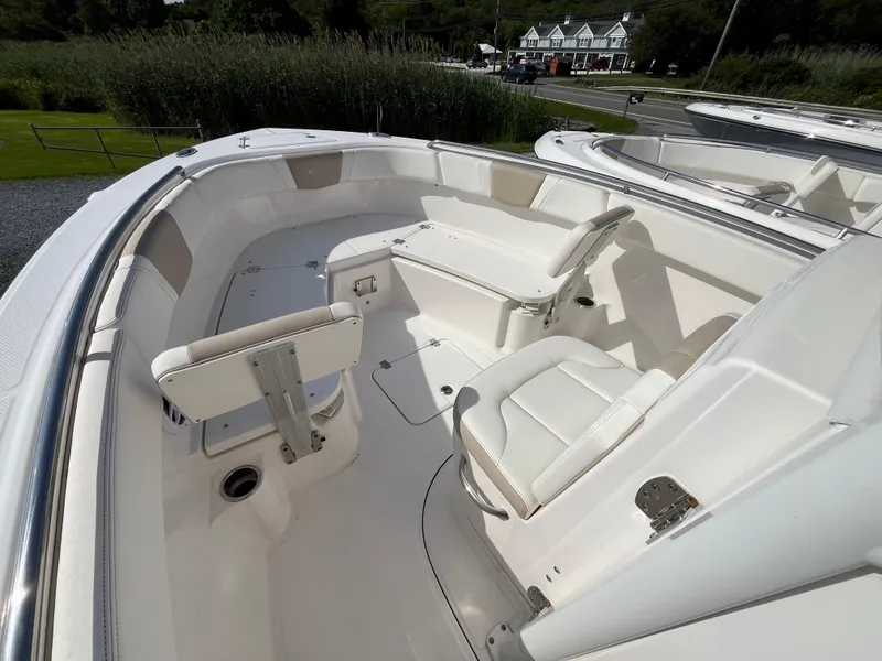 Slide: The Image of 2024 Robalo R230 Center Console boat interior with seating and storage compartments. - 9