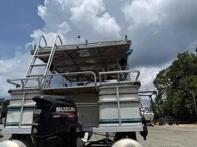 Slide: The Image of 1998 Crest III 25 pontoon boat with Suzuki 140 outboard motor, parked under cloudy sky. - 16