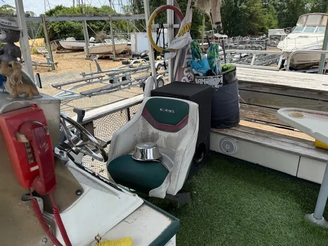 Slide: The Image of 1998 Crest III 25 boat interior with captain's chair, steering wheel, and outdoor equipment. - 8