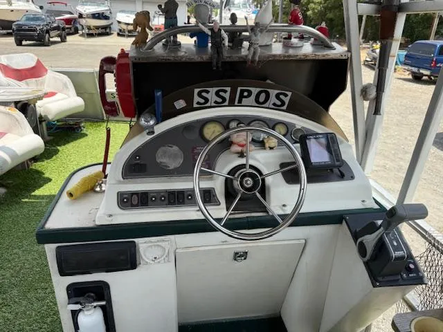 Slide: The Image of 1998 Crest III 25 boat dashboard with steering wheel and control panel. - 9