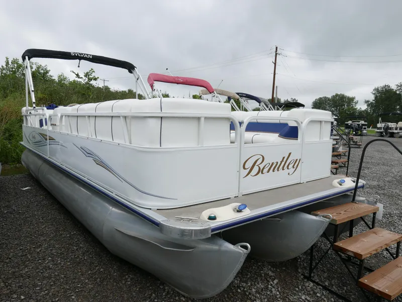 Slide: The Image of 2006 Bentley Pontoons 240 CRUISE pontoon boat on gravel lot, overcast sky. - 1