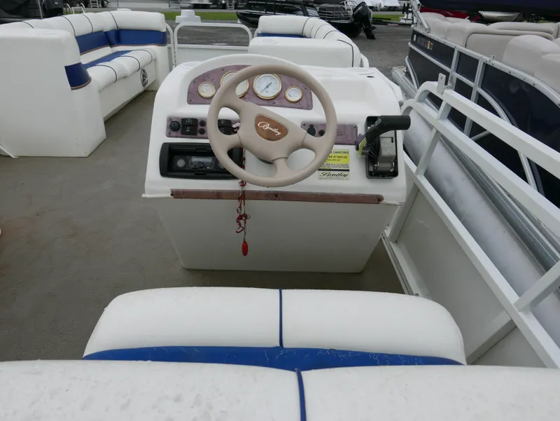 Slide: The Image of 2006 Bentley Pontoons 240 CRUISE helm with steering wheel and seating area. - 10