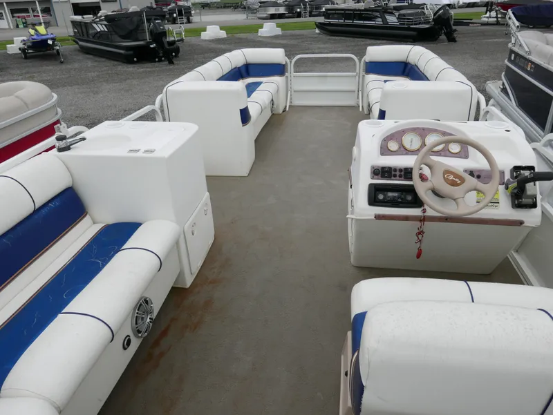 Slide: The Image of 2006 Bentley Pontoons 240 CRUISE interior with blue and white seating, steering console, and spacious layout. - 12