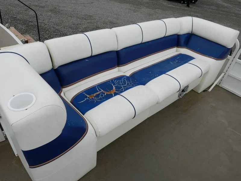 Slide: The Image of 2006 Bentley Pontoons 240 CRUISE seating with blue and white upholstery, showing wear and tear. - 6