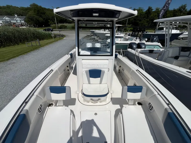 Slide: The Image of 2024 Robalo R250 Center Console boat interior with seating and console view. - 13