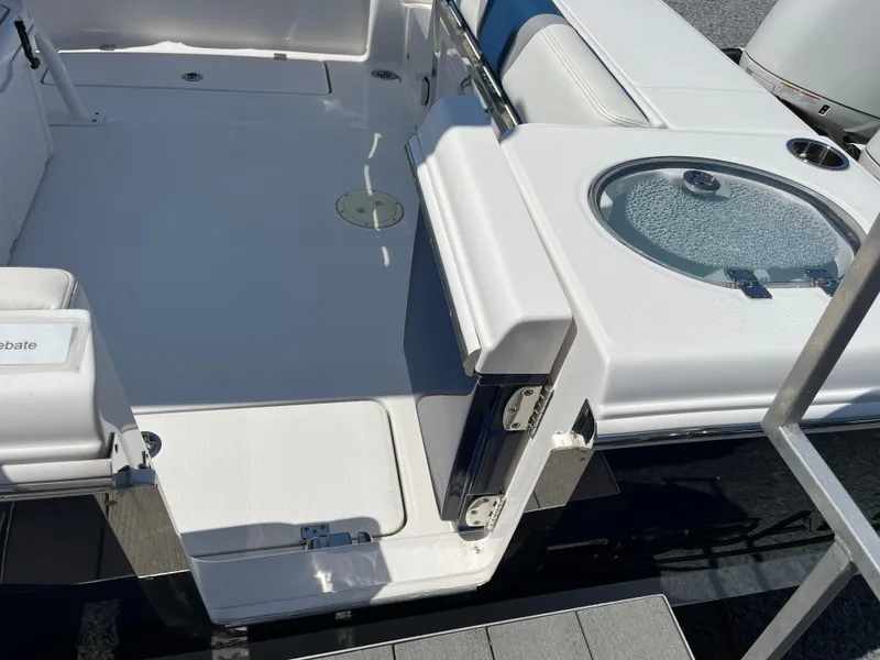Slide: The Image of 2024 Robalo R250 Center Console boat deck with seating and livewell. - 3