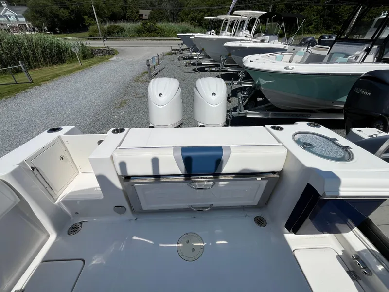 Slide: The Image of 2024 Robalo R250 Center Console boat with dual engines and spacious deck layout. - 5