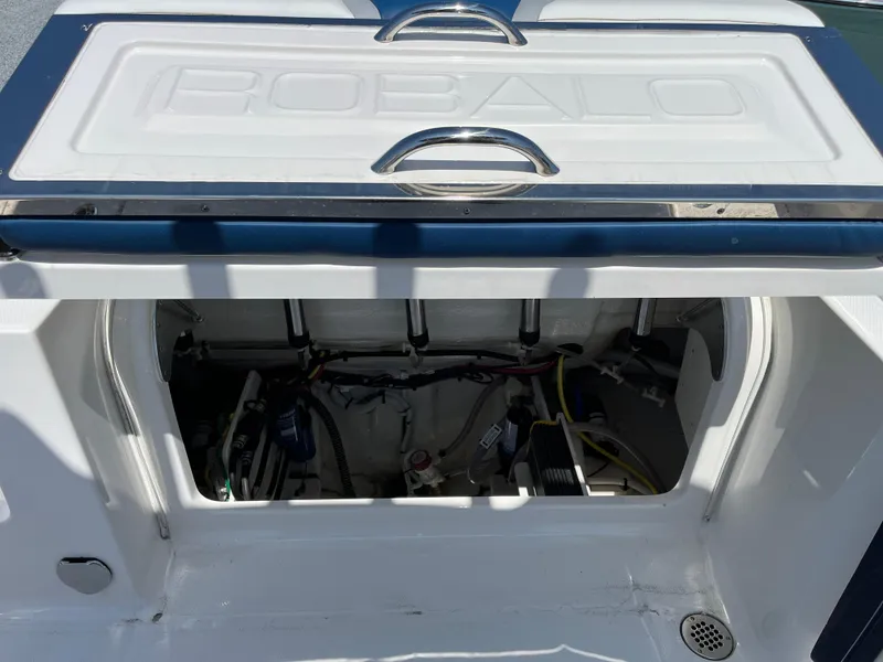 Slide: The Image of 2024 Robalo R250 Center Console boat storage compartment with open hatch. - 6